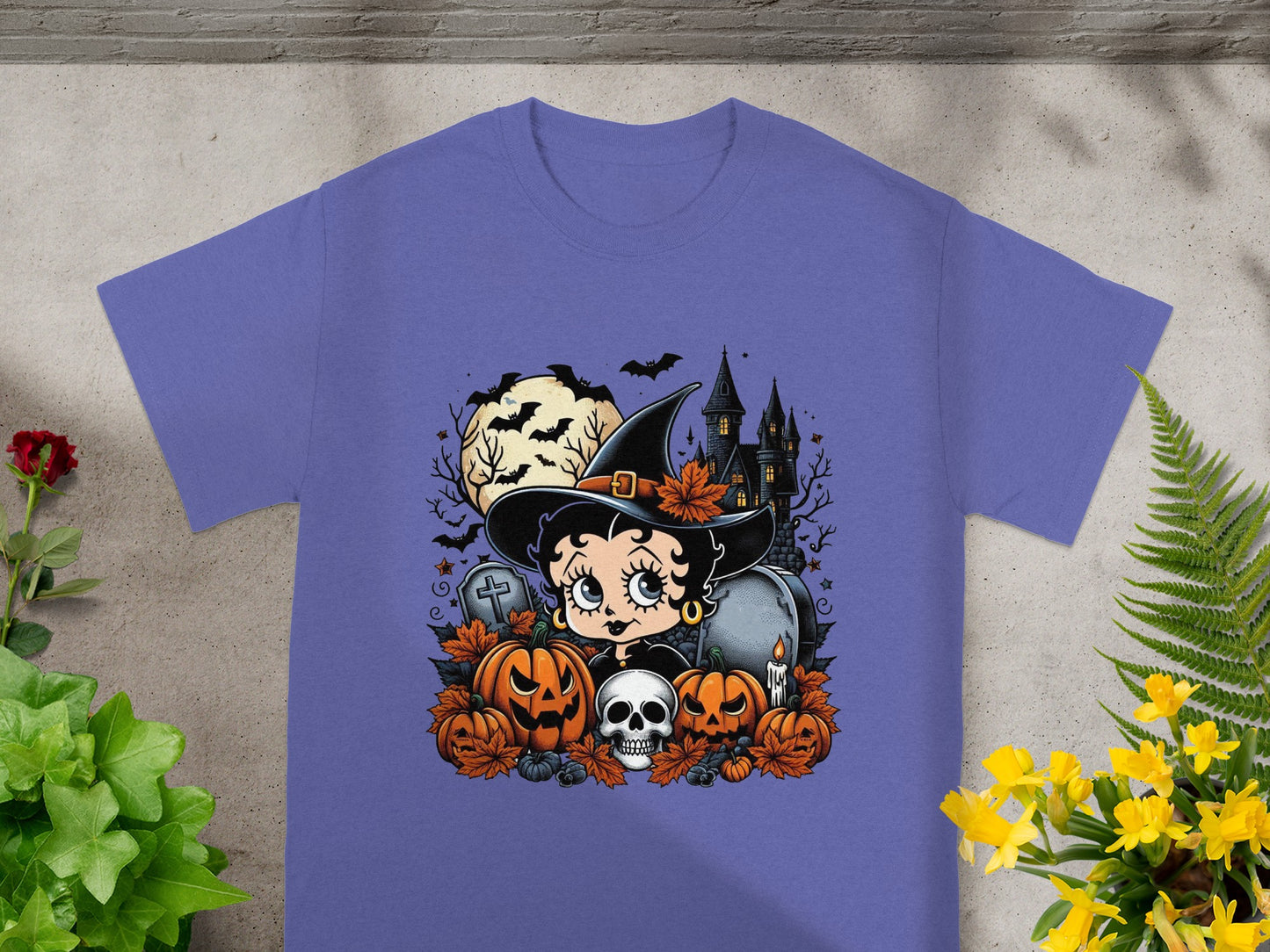 Betty Boop in a witch hat with pumpkins, skull, haunted house, and bats.