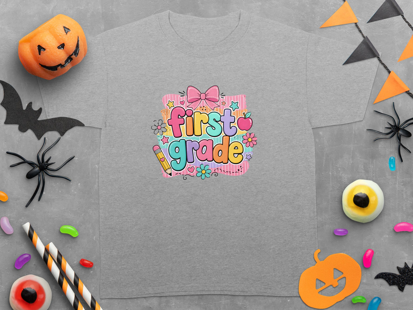 Grey t-shirt with "first grade" text and Halloween decorations.