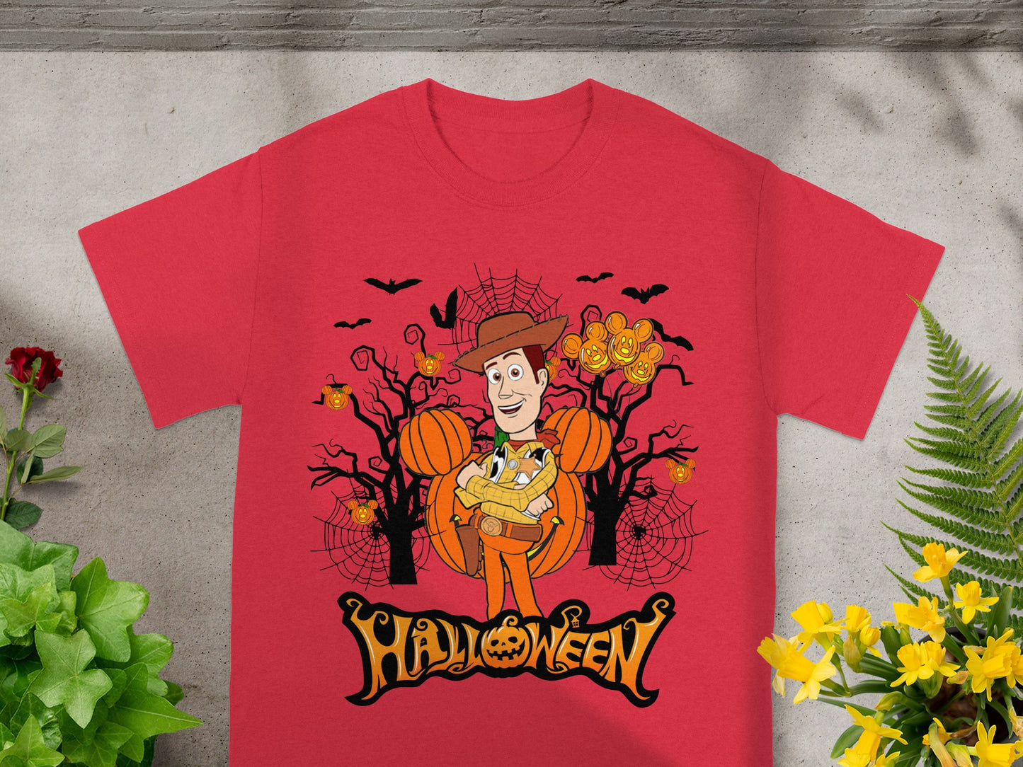 Red t-shirt featuring Woody character with pumpkins, bats, and "Halloween" text.