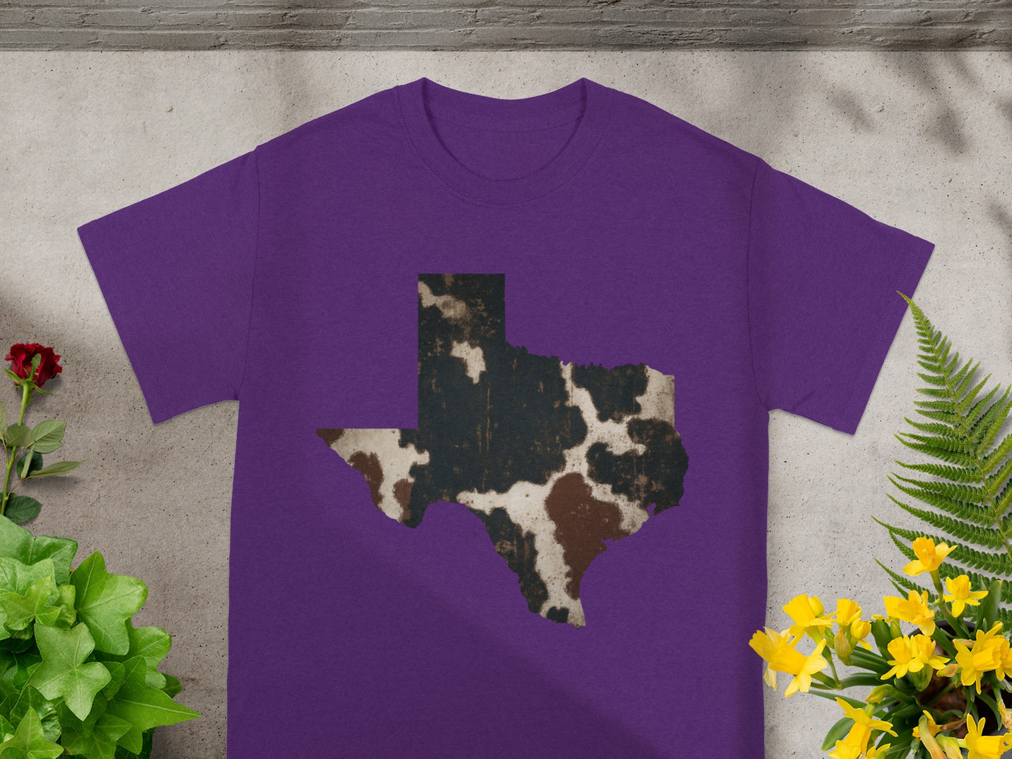 Purple t-shirt with a distressed cowhide pattern in the shape of Texas.