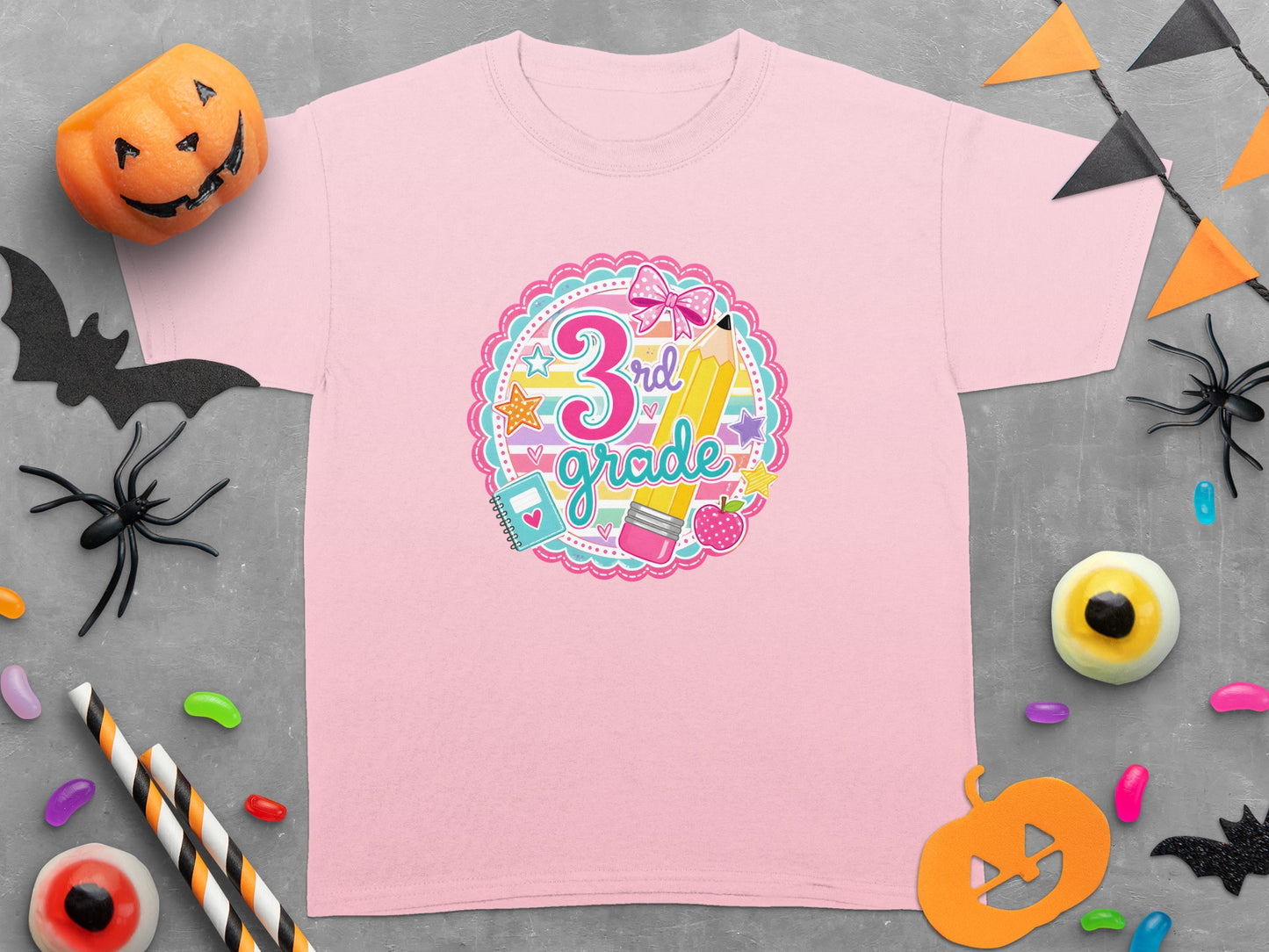 Pink t-shirt with "3rd grade" design featuring school supplies and a bow.