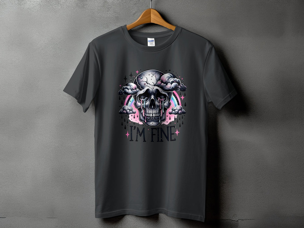 Dark grey t-shirt featuring a skull crying amidst clouds, with a rainbow and the text "I'M FINE".