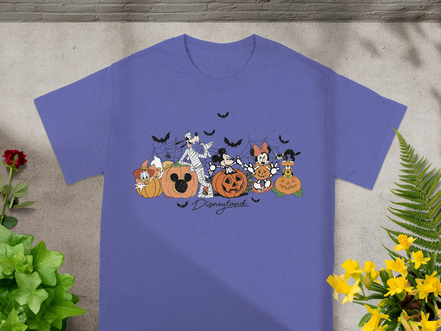 Disney characters in Halloween costumes with pumpkins and text, "Disneyland."