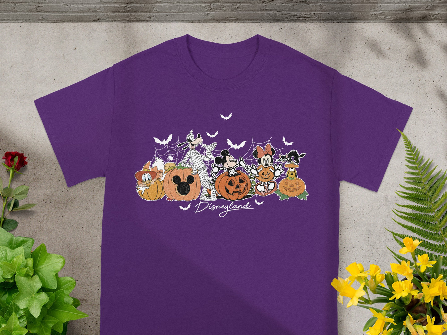 Purple t-shirt with Disneyland Halloween characters and pumpkins graphic.
