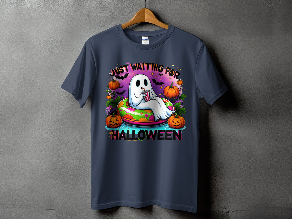 Ghost in inner tube with pumpkins says "Just Waiting For Halloween".