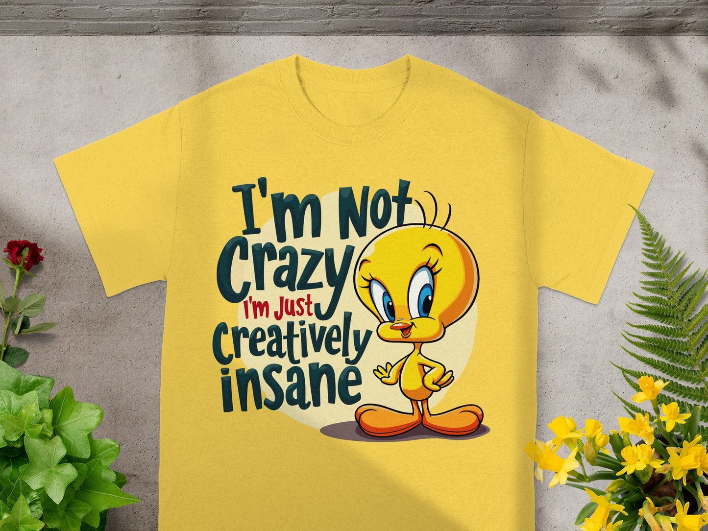 Yellow t-shirt with Tweety Bird saying "I'm not crazy, I'm just creatively insane."