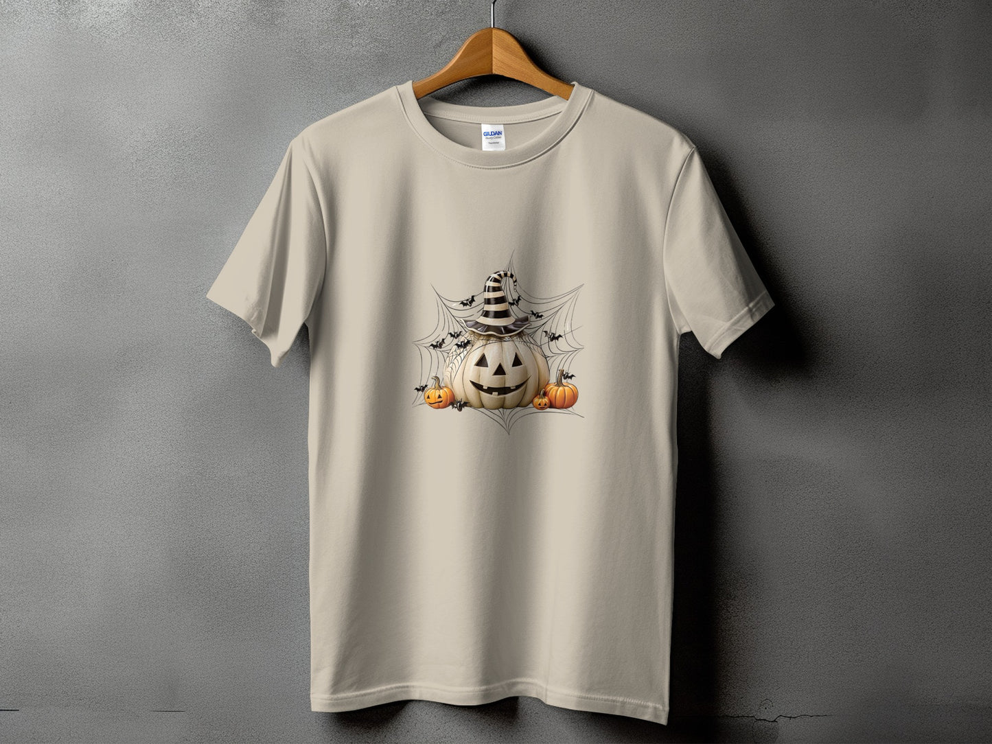 Light beige t-shirt with Halloween pumpkin graphic, bats, and spiderwebs.