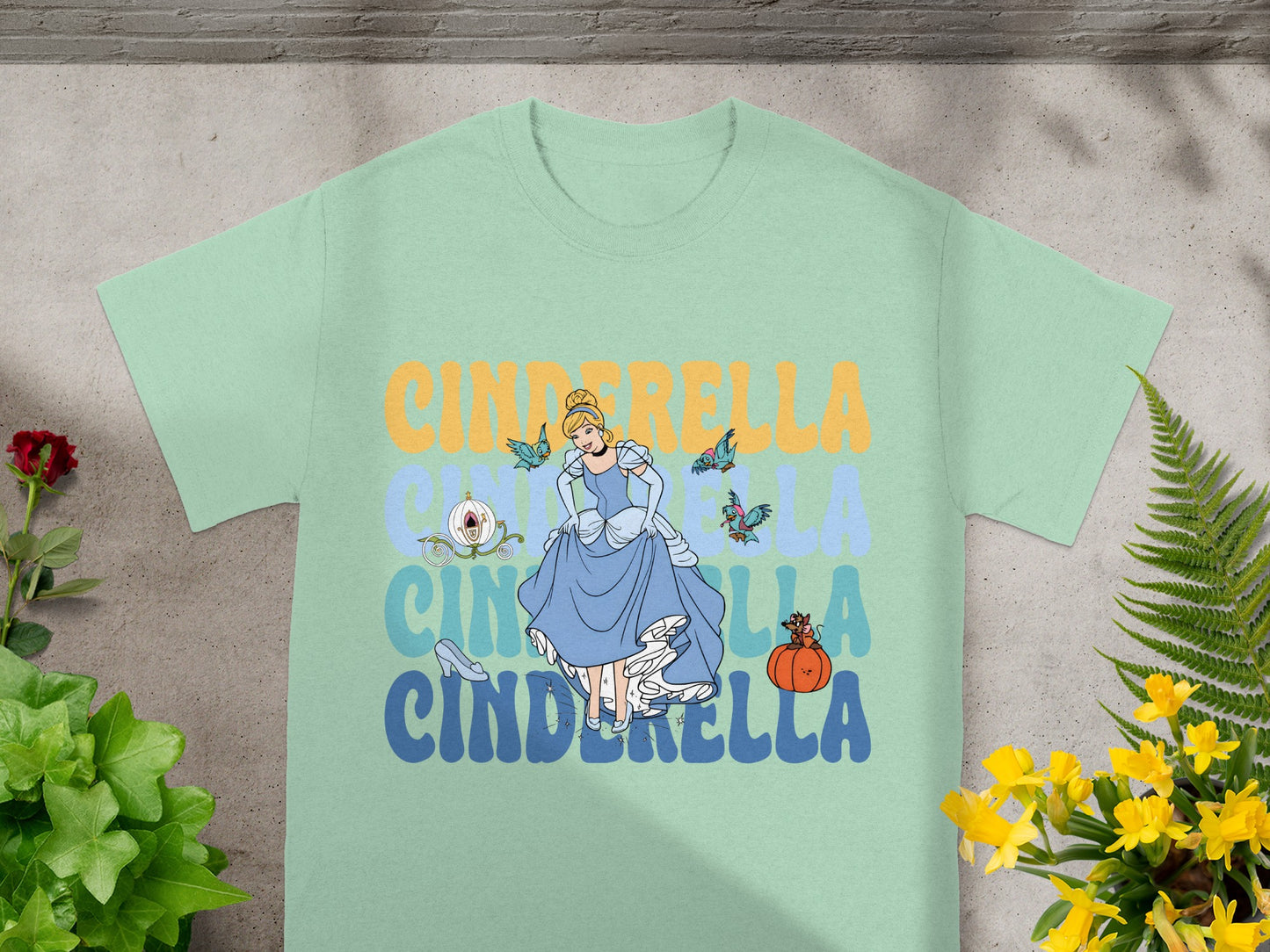 Light blue t-shirt with Cinderella graphic and text.