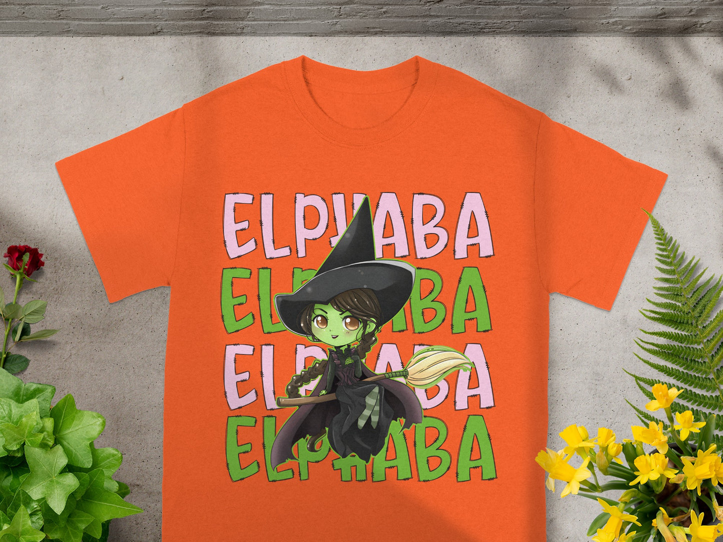 Orange t-shirt with a witch graphic and "ELPHABA" text.