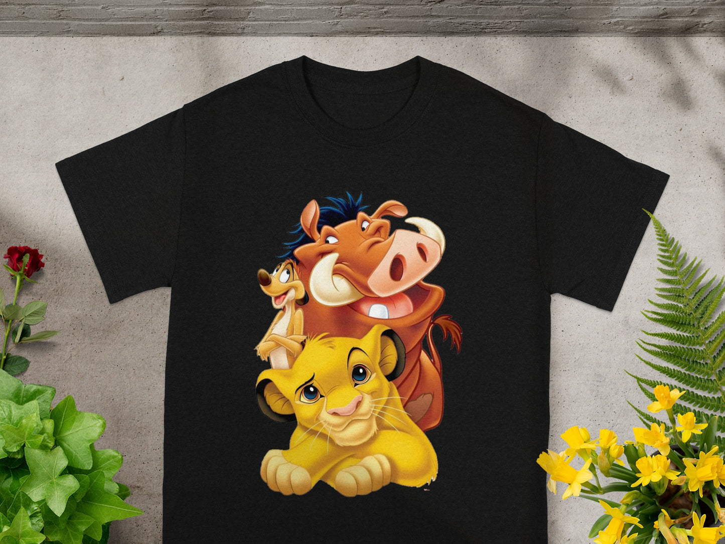 Simba, Timon, and Pumbaa from The Lion King on a black t-shirt.