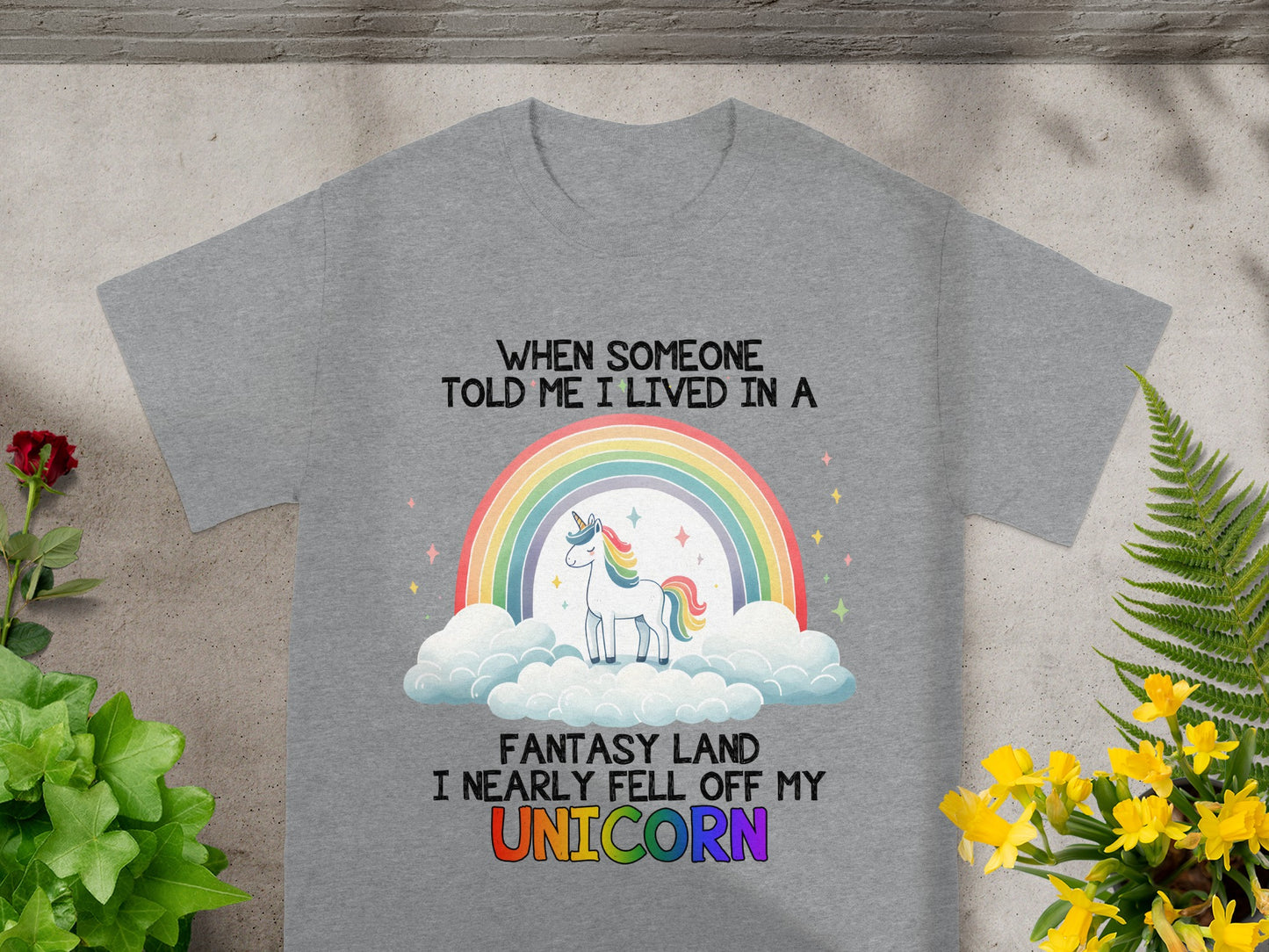 Grey t-shirt with text: When someone told me I lived in a fantasy land I nearly fell off my unicorn.