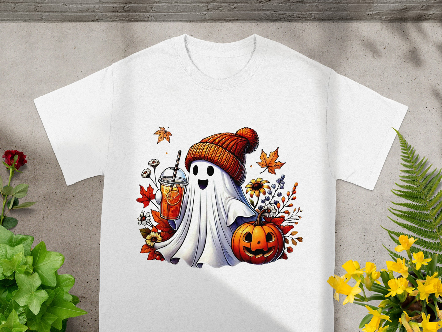 Ghost in beanie holding drink with pumpkin and autumn leaves.