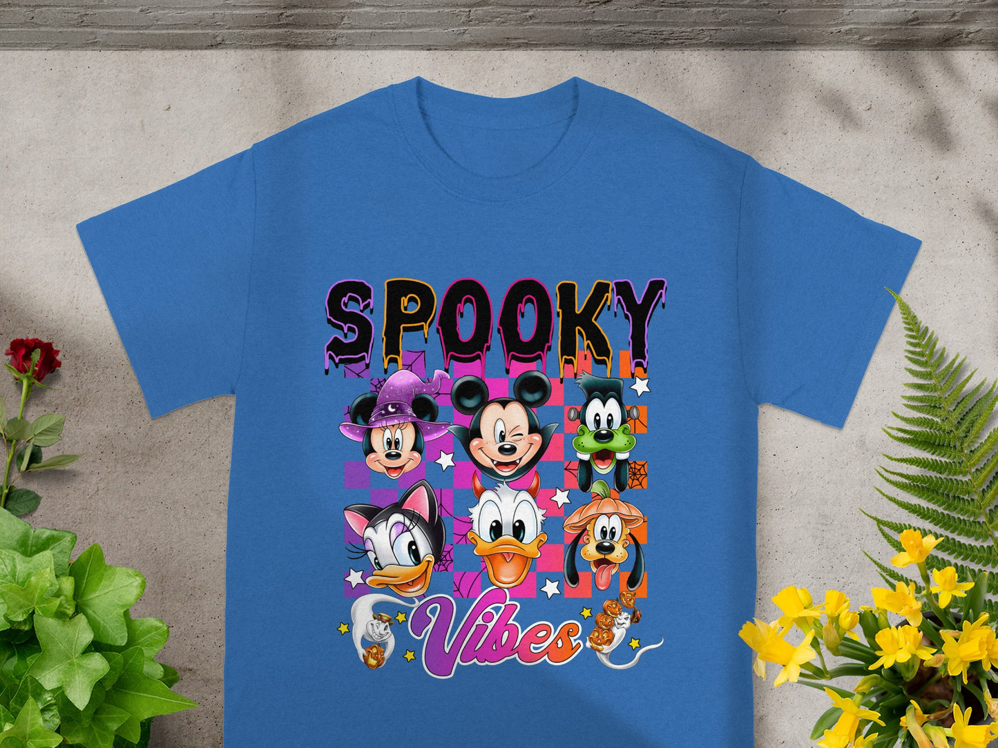 Disney characters in Halloween costumes with "Spooky Vibes" text on a blue shirt.