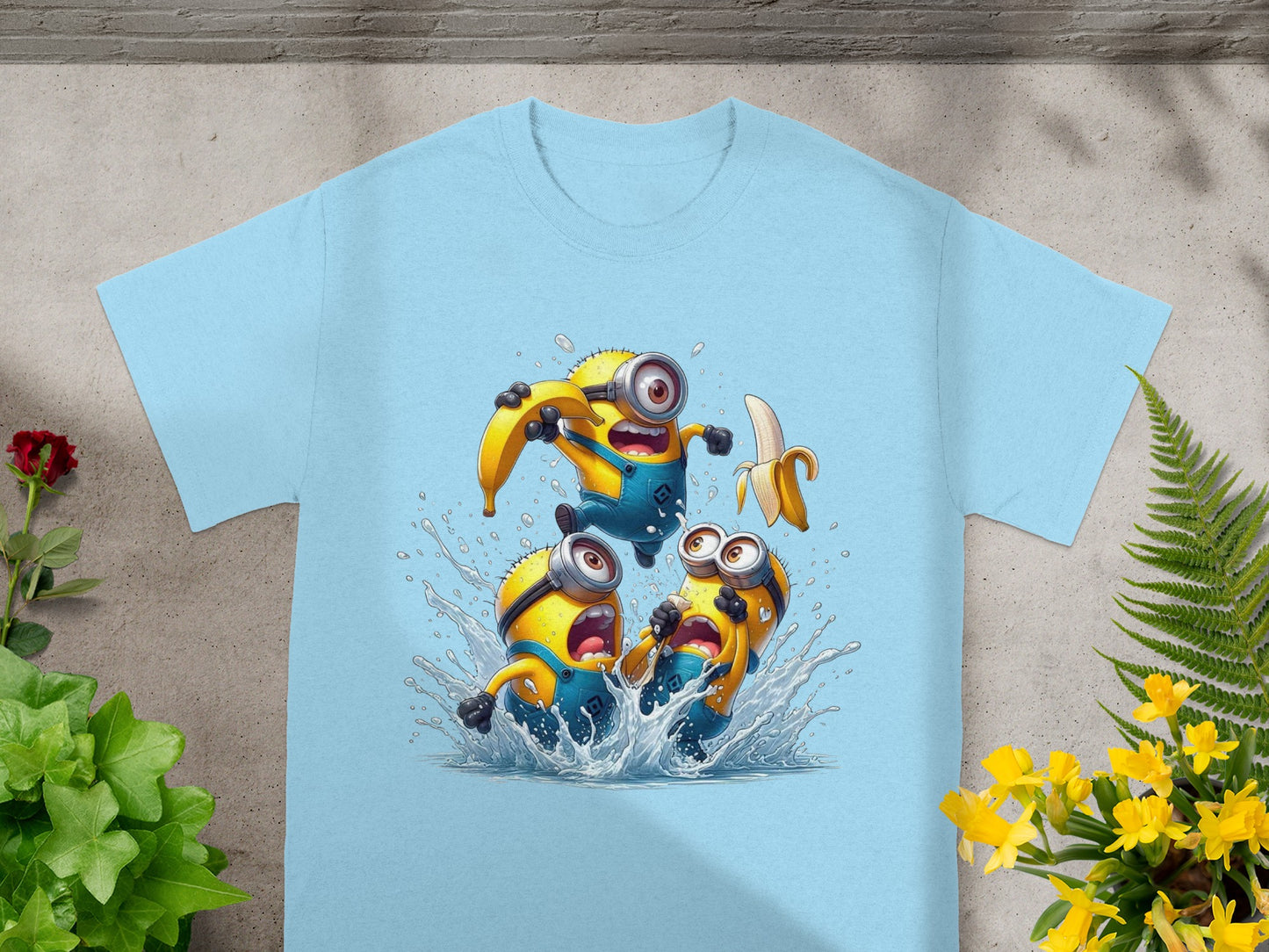 Light blue t-shirt with a graphic of three splashing Minions holding bananas.