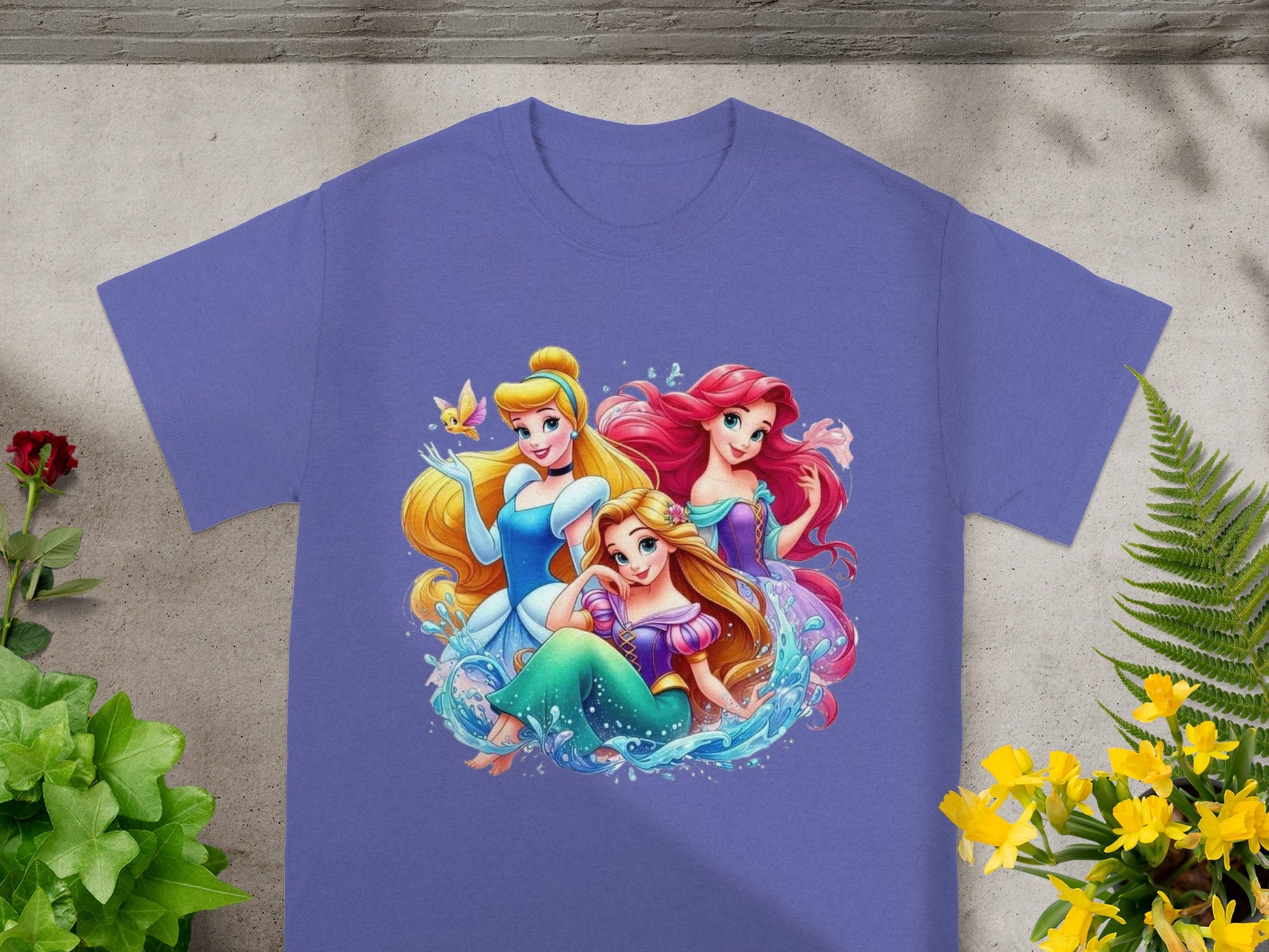 Disney Princesses Ariel, Cinderella, and Rapunzel on a purple t-shirt.