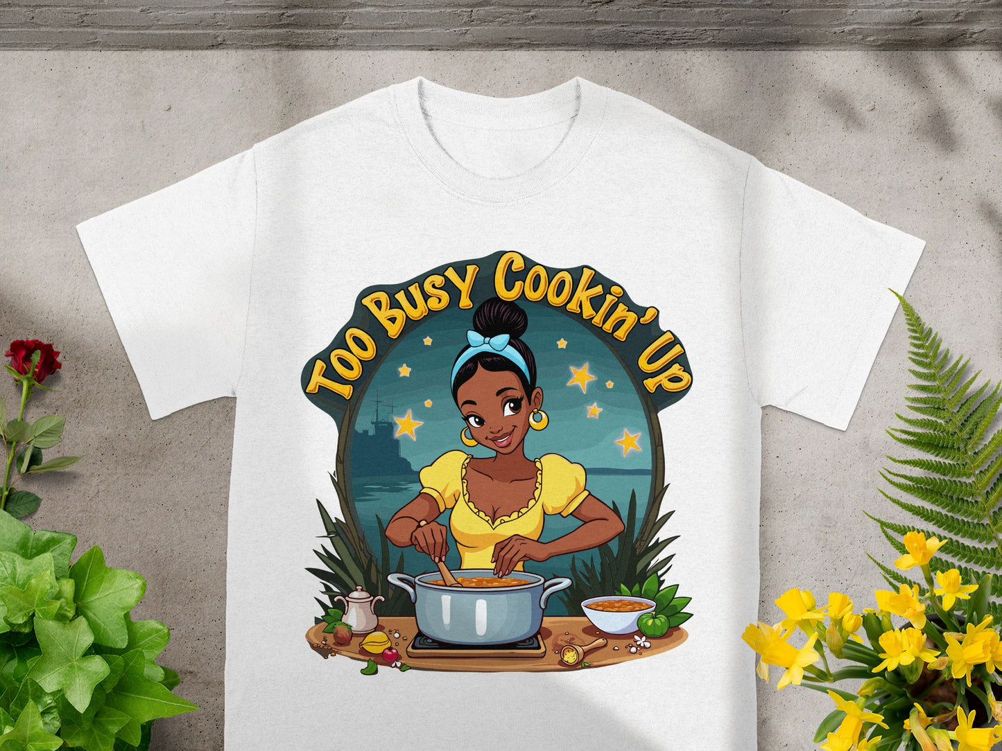 Tiana cooking in a pot with "Too Busy Cookin' Up" text.