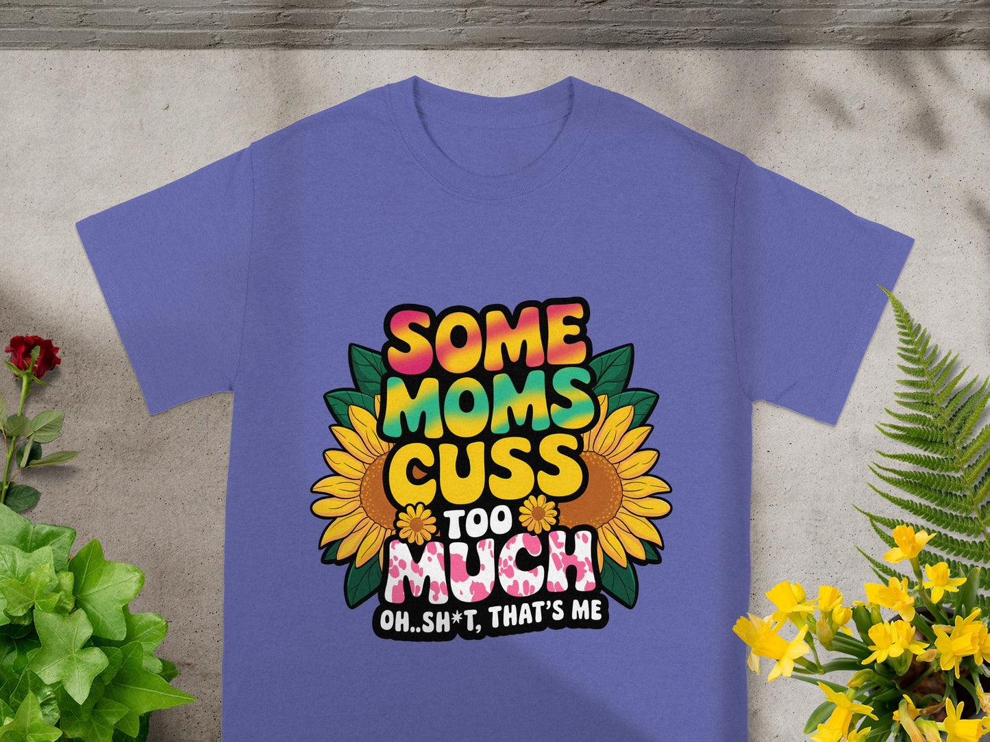 Purple t-shirt with "Some moms cuss too much Oh..sh*t, that's me" graphic and sunflowers.