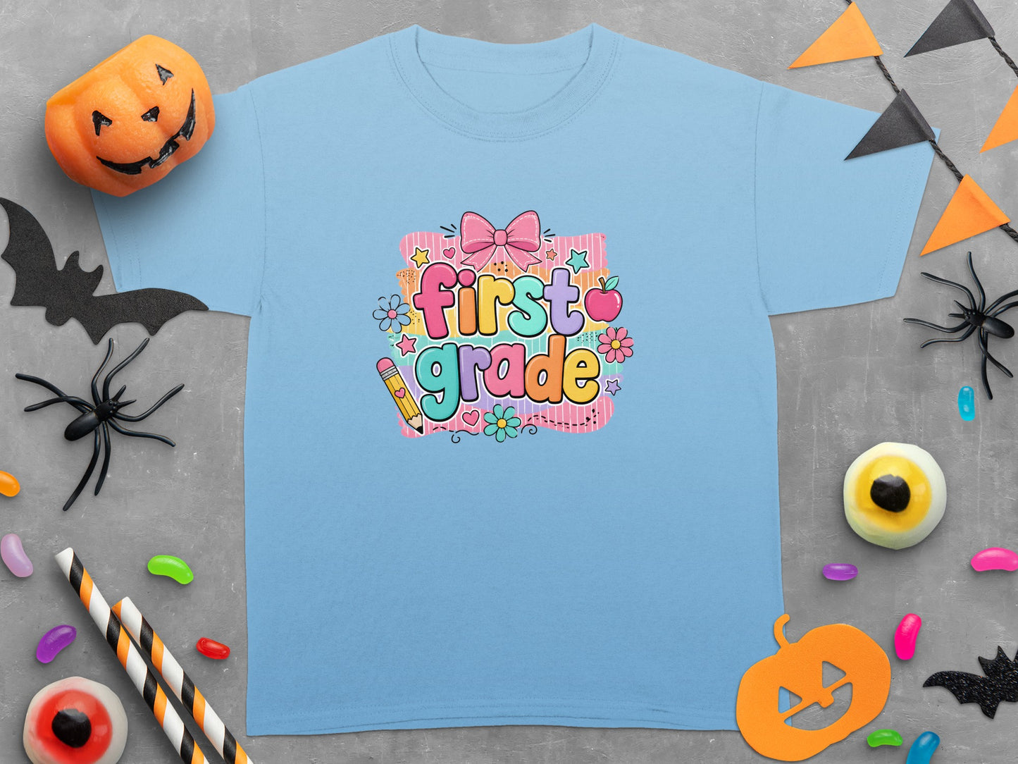 Light blue t-shirt with "first grade" text and cartoon designs.