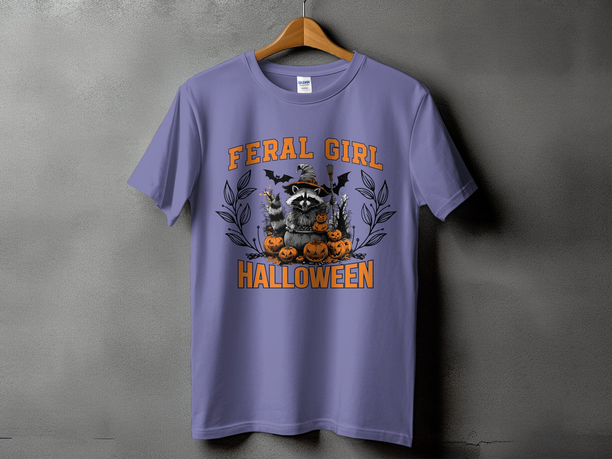 Purple t-shirt with a raccoon in a witch hat surrounded by pumpkins and bats.