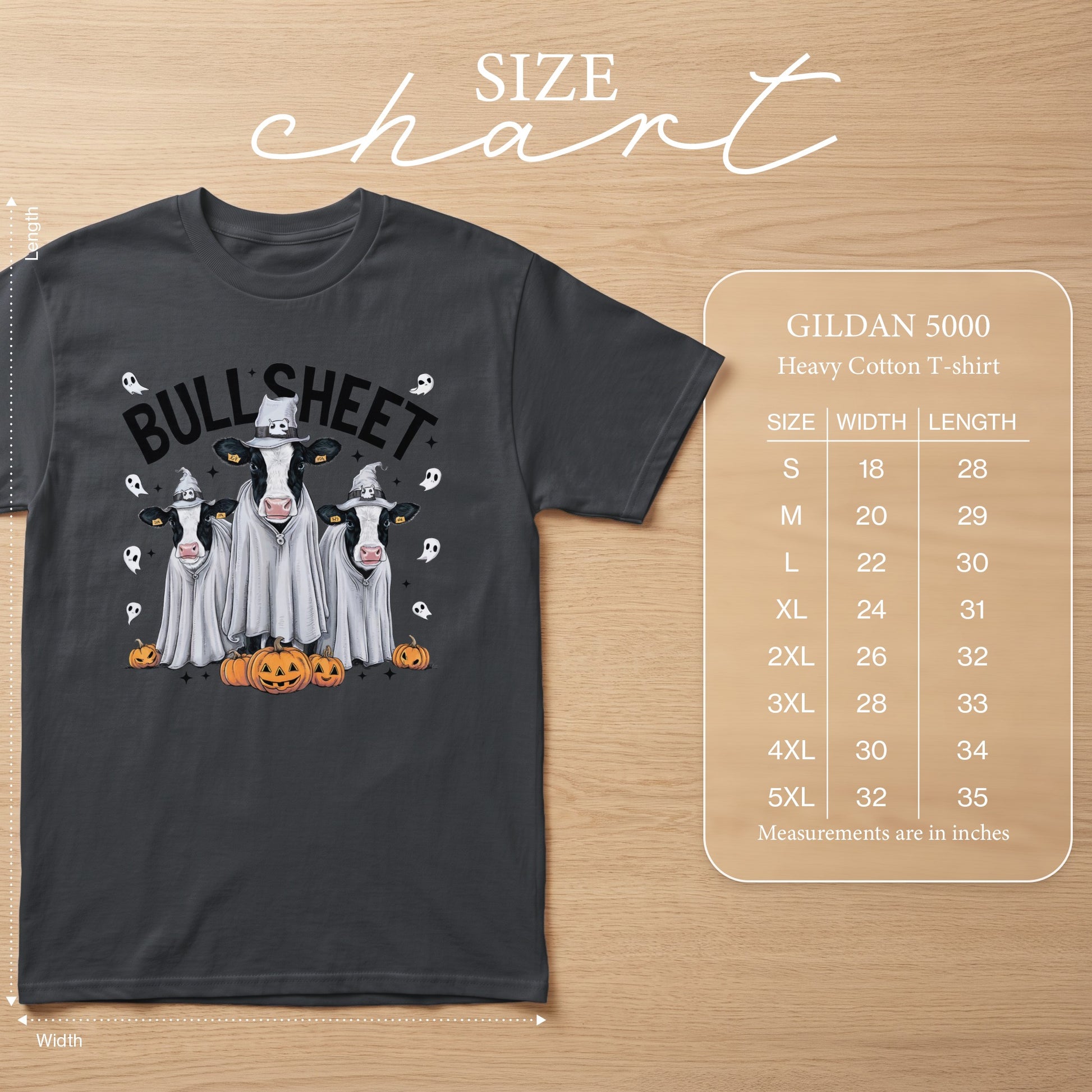 Dark grey t-shirt with cows in ghost costumes and pumpkins, featuring "BULLSHEET" text and size chart.