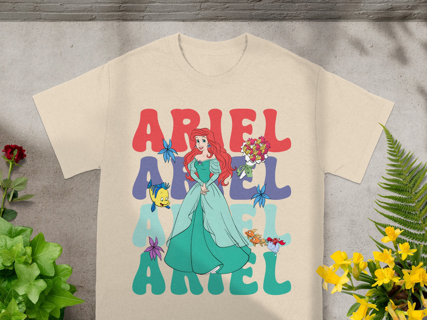 Ariel from The Little Mermaid on a cream t-shirt with her name repeated.
