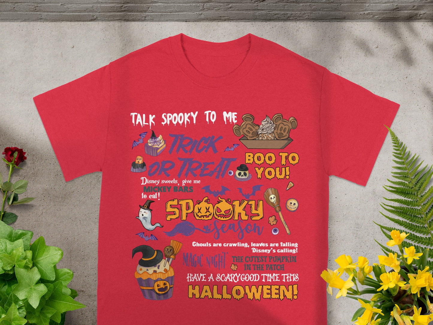 Red t-shirt with Halloween-themed Disney graphics and text.