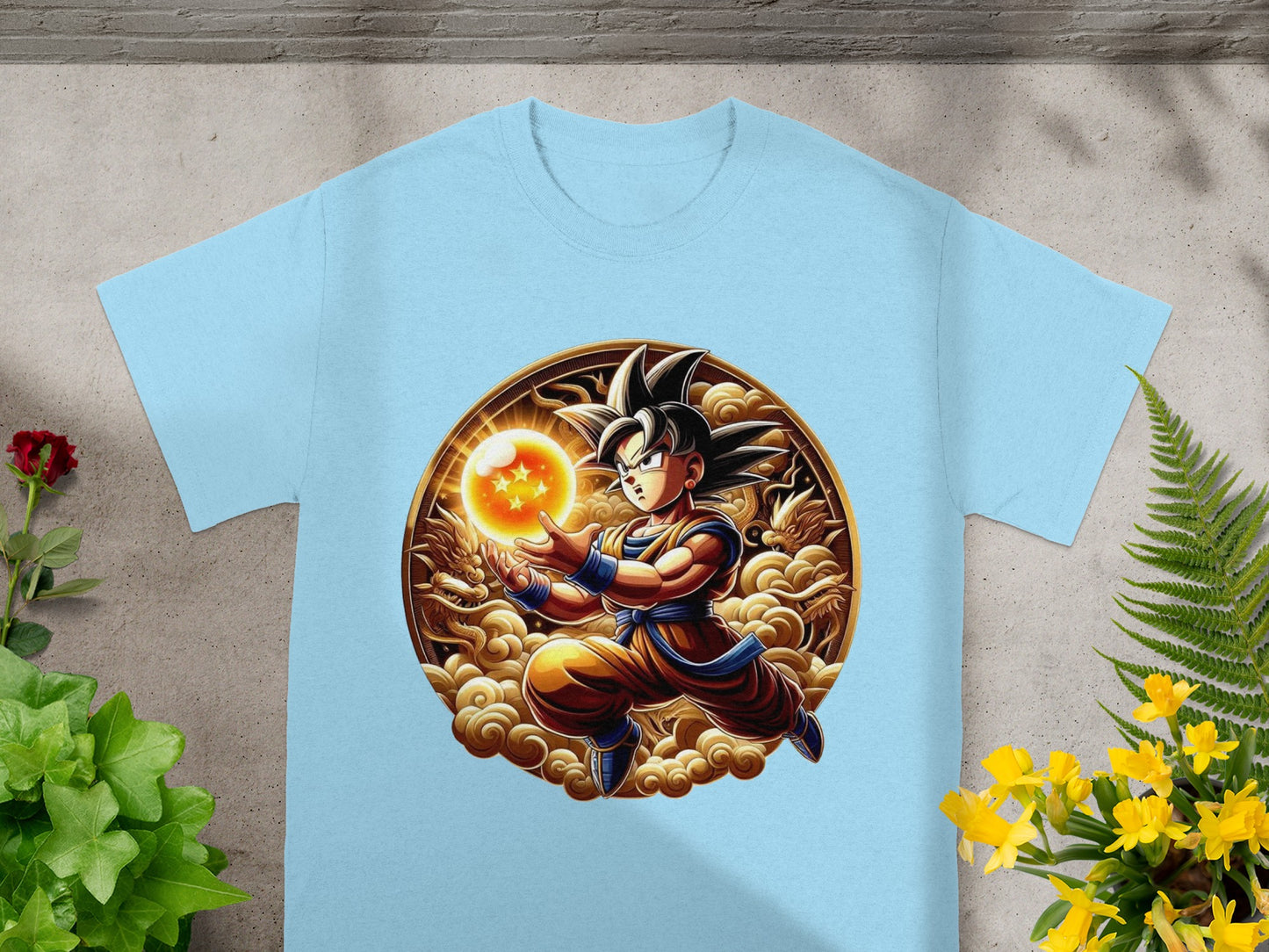 Goku in orange gi, powering up a Spirit Bomb, on a light blue t-shirt.