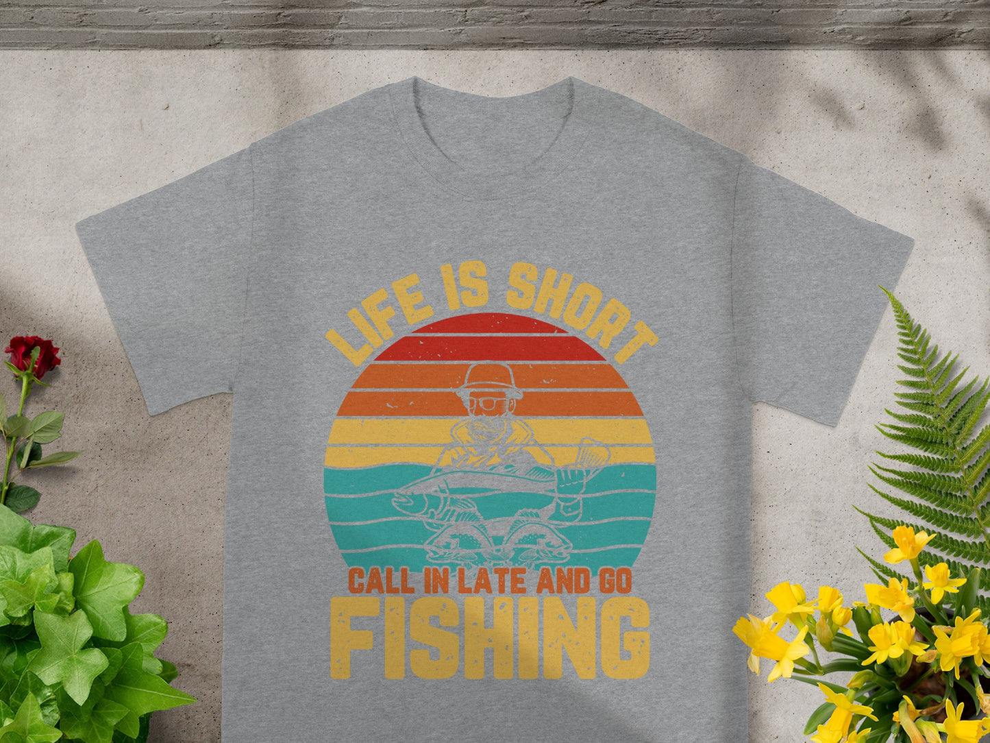 Grey t-shirt with vintage sunset fishing graphic and text: "LIFE IS SHORT CALL IN LATE AND GO FISHING".
