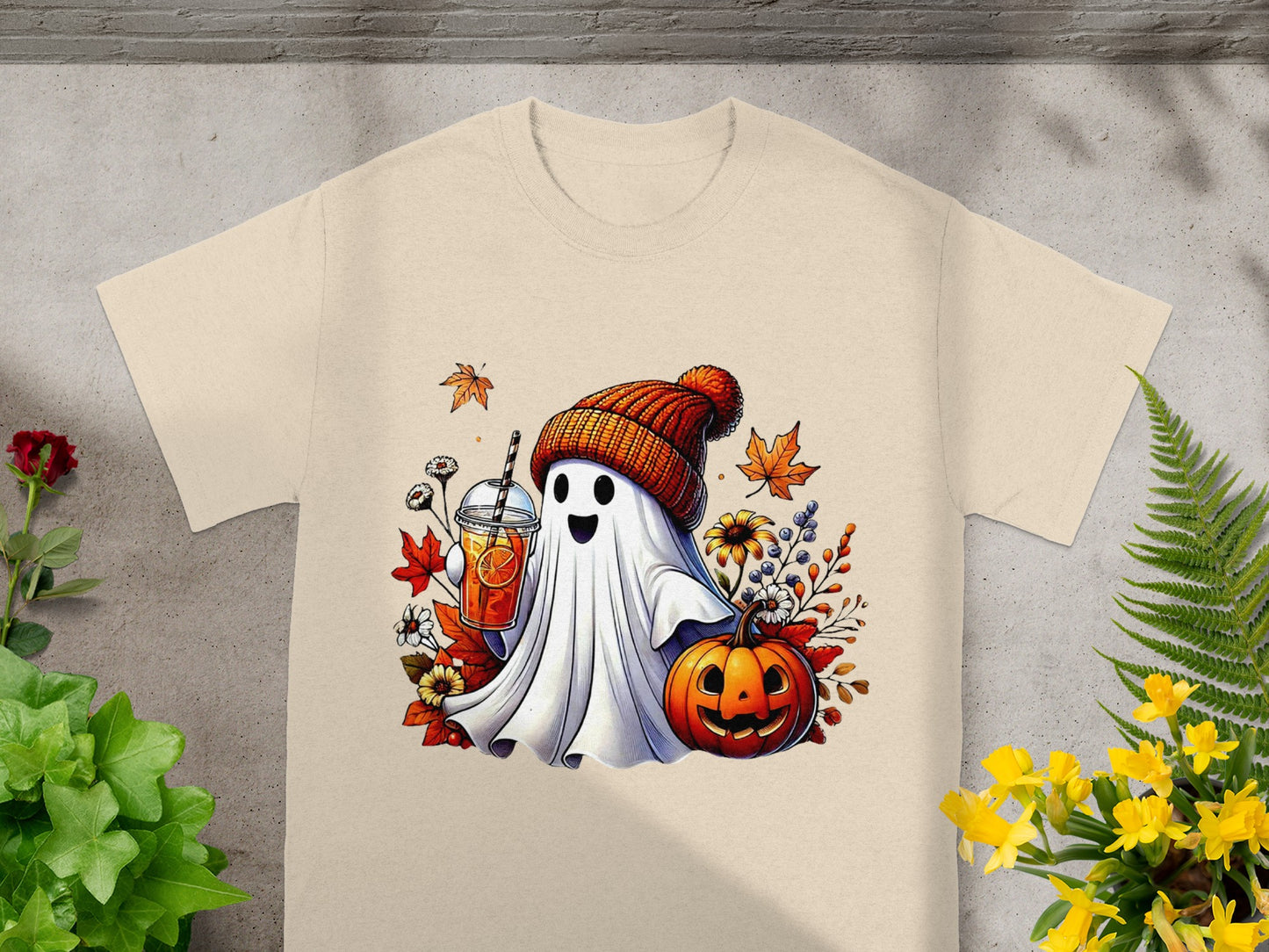Ghost wearing beanie holding drink with pumpkin and autumn leaves.