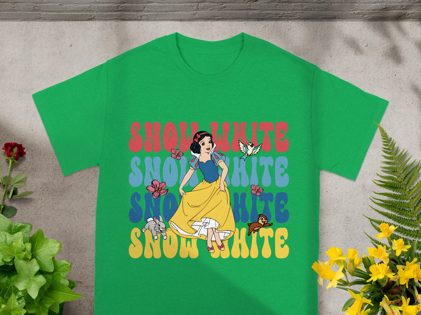 Green t-shirt with Snow White graphic and "Snow White" text in colorful blocks.