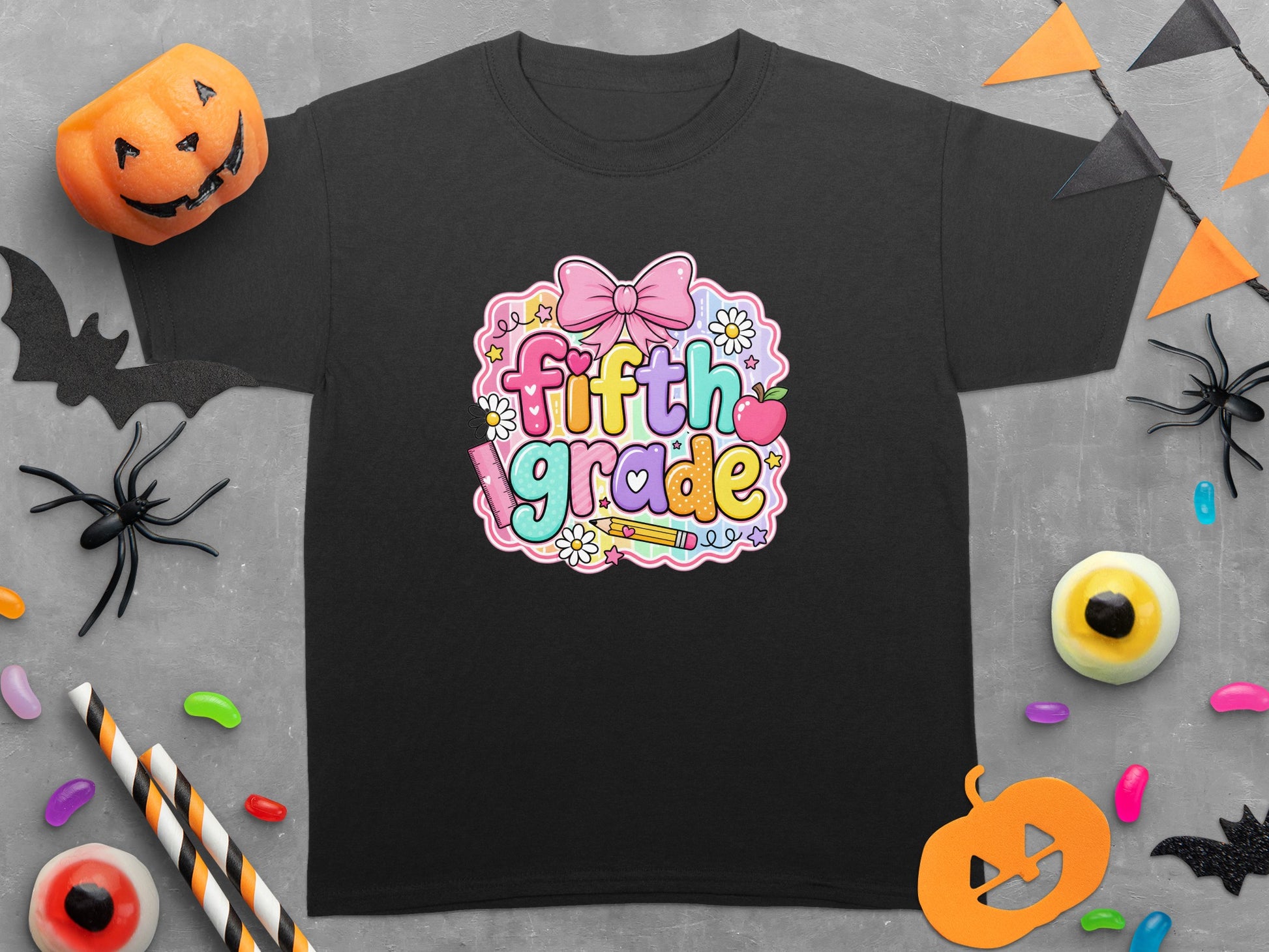 Black t-shirt with colorful "fifth grade" text and Halloween decorations.