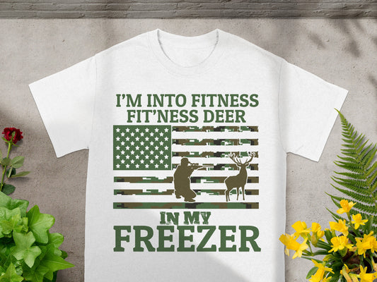 White t-shirt with "I'm Into Fitness Fit'ness Deer In My Freezer" text and camouflage flag.