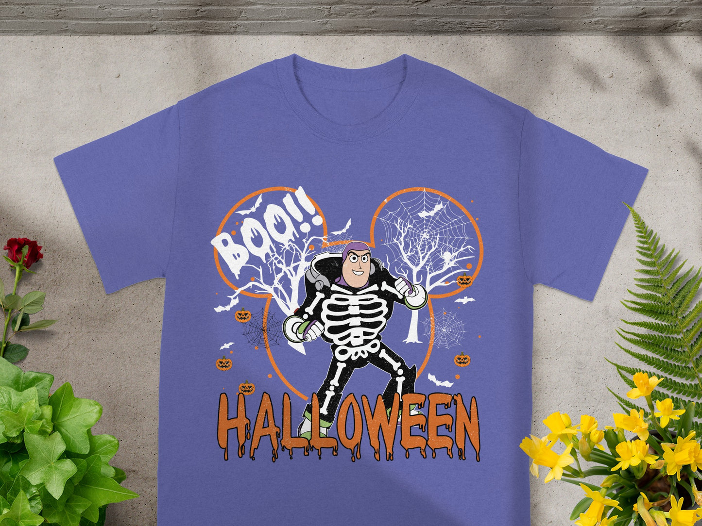 Buzz Lightyear skeleton Halloween graphic with "Boo!!" text on a purple t-shirt.