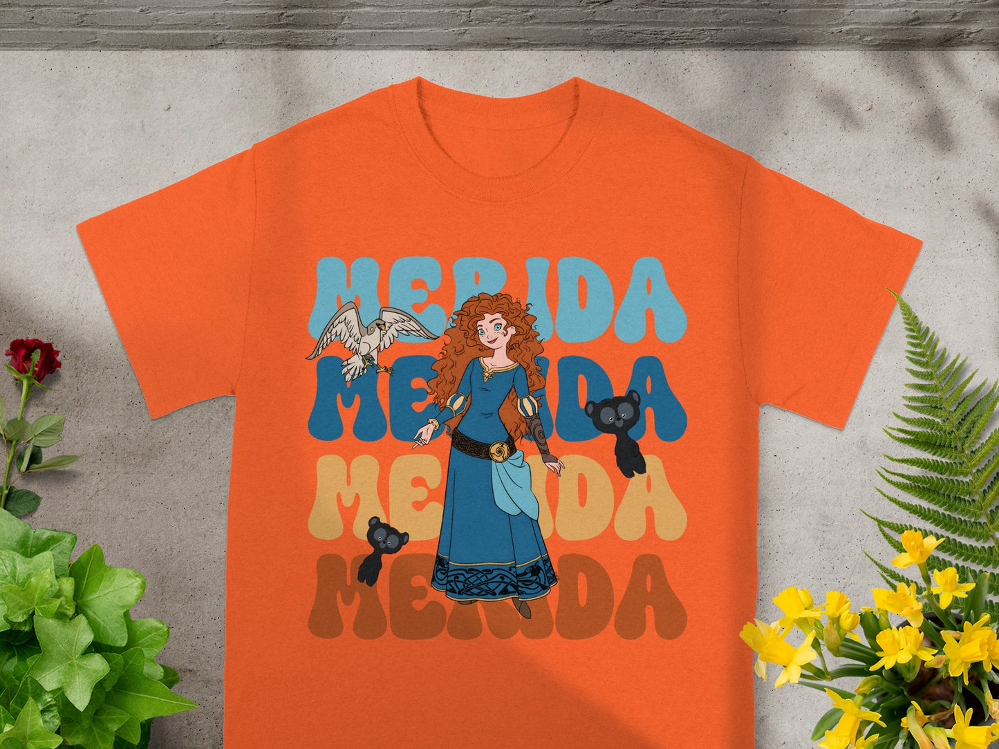 Merida from Brave with her animal companions on an orange t-shirt.