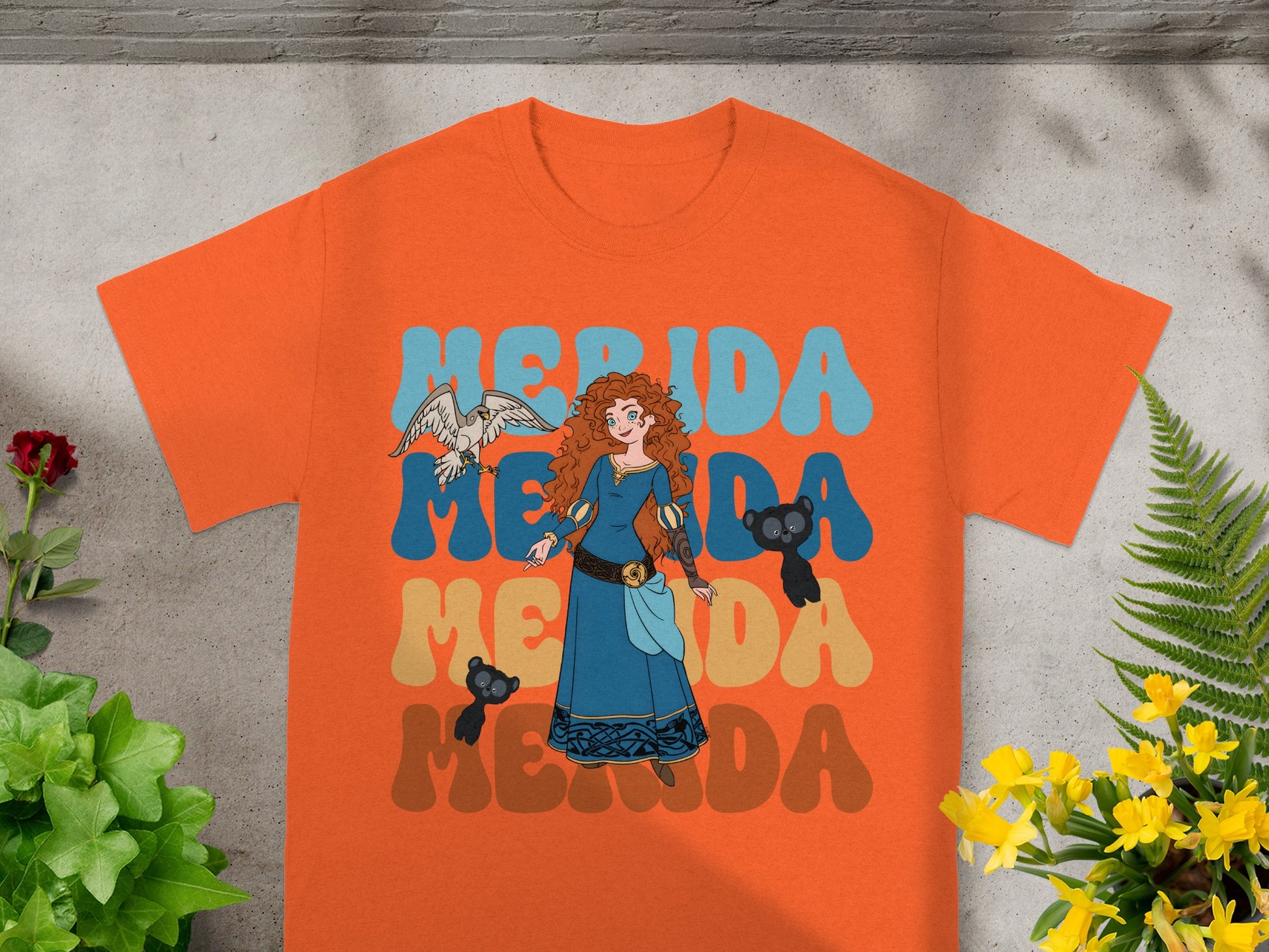 Merida from Brave with her animal companions on an orange t-shirt.