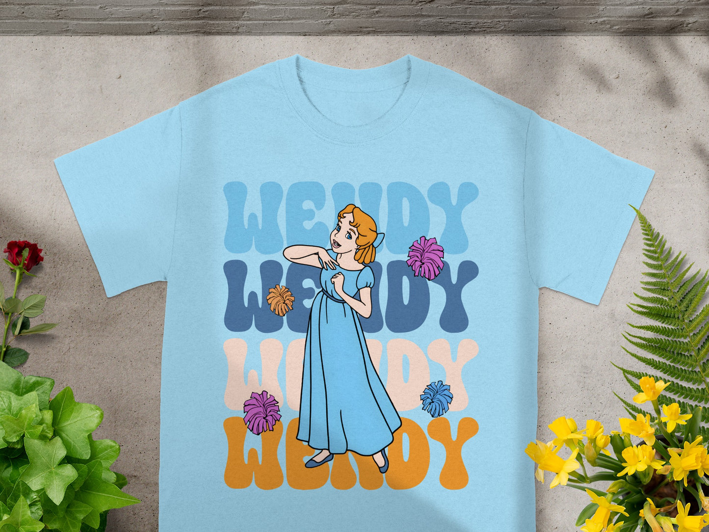 Blue t-shirt with "Wendy" in large, colorful letters and a cartoon character.