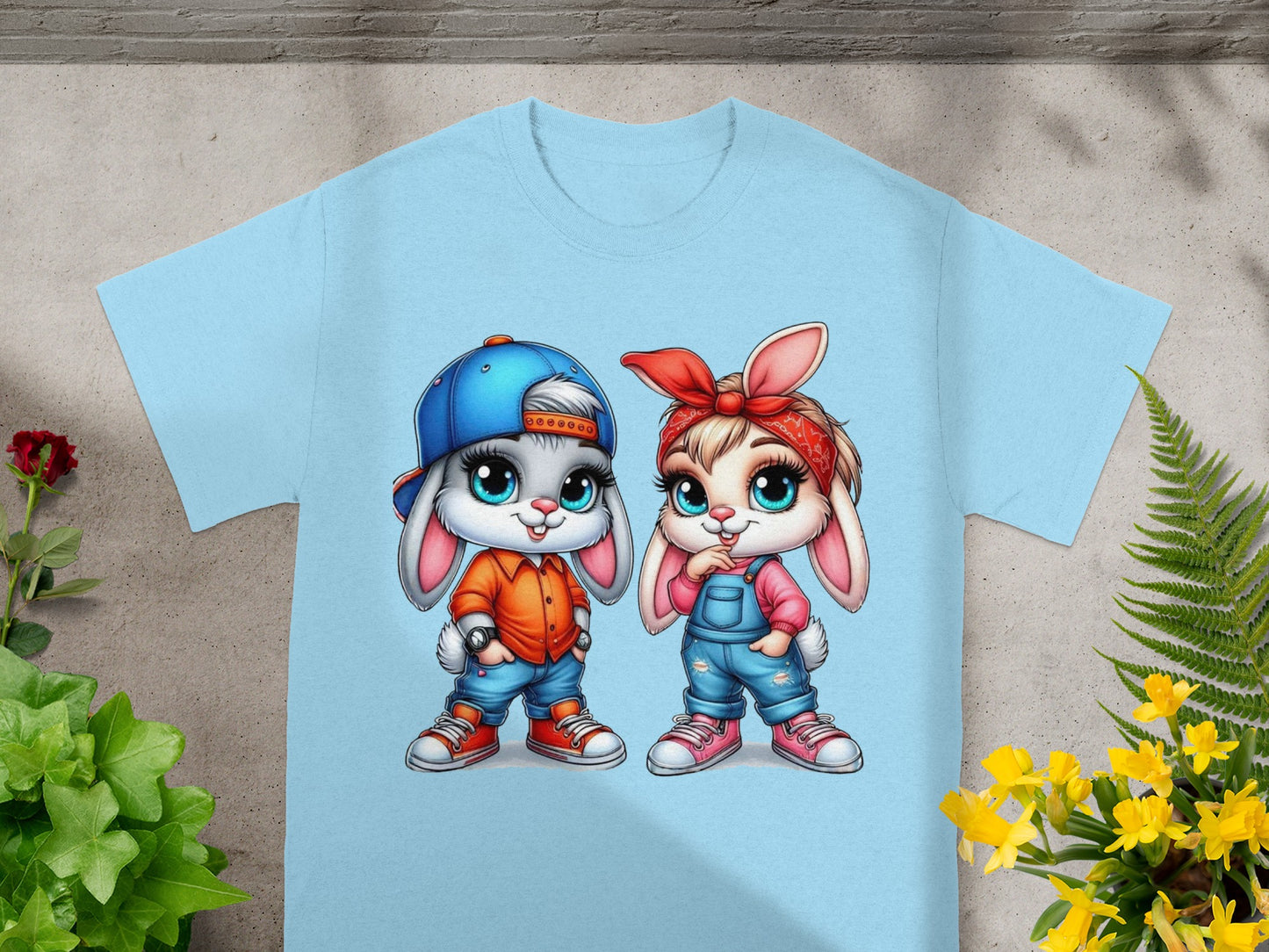 Two cartoon bunnies in blue overalls and shirts on a light blue t-shirt.