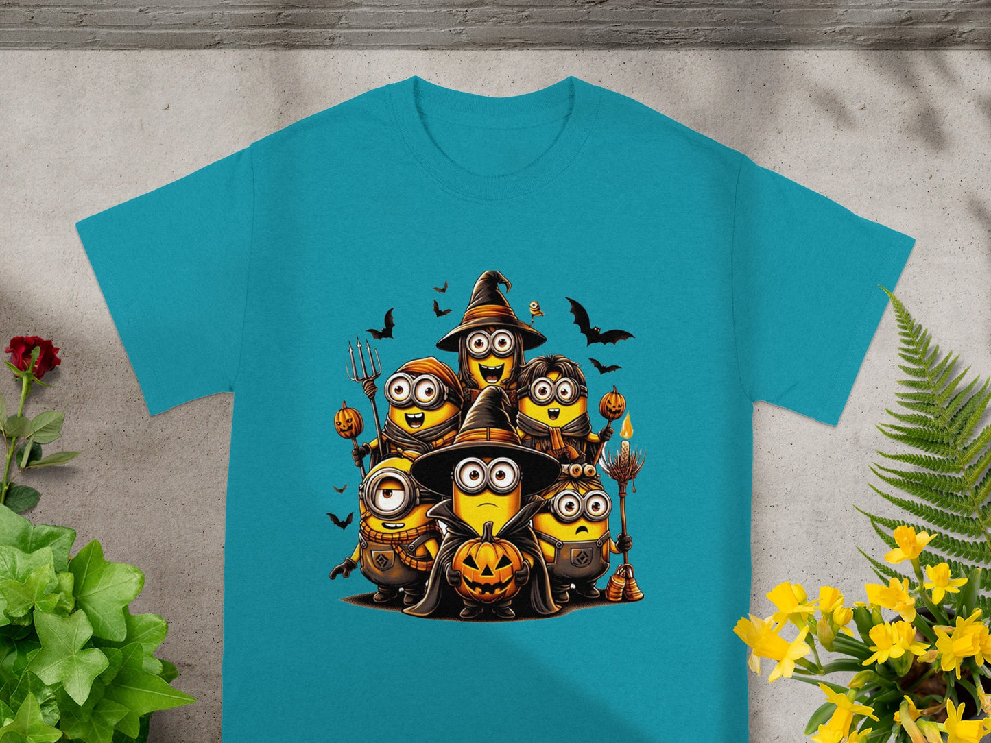 Minions in Halloween costumes holding pumpkins and witch accessories with bats and a torch.