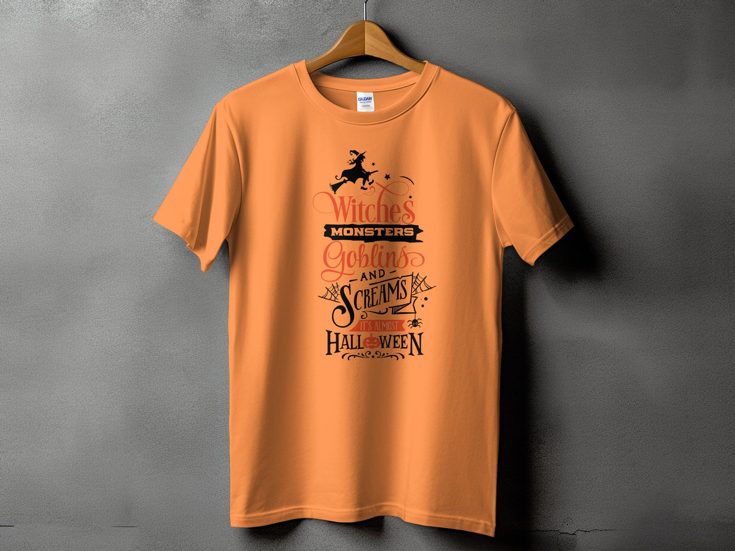 Orange t-shirt with "Witches, Monsters, Goblins and Screams It's Almost Halloween" Halloween graphic.