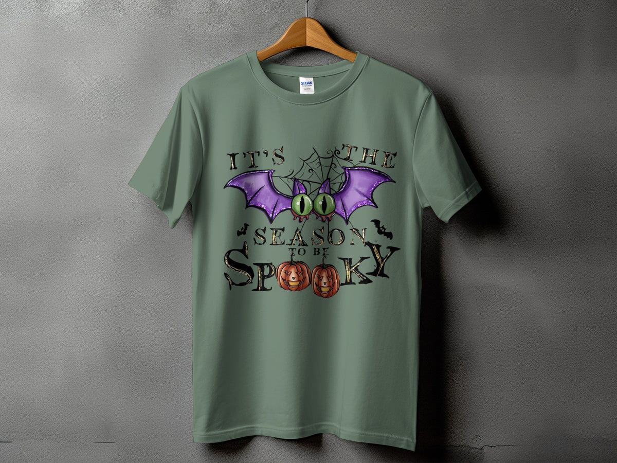 Green t-shirt with "It's the season to be spooky" Halloween graphic.