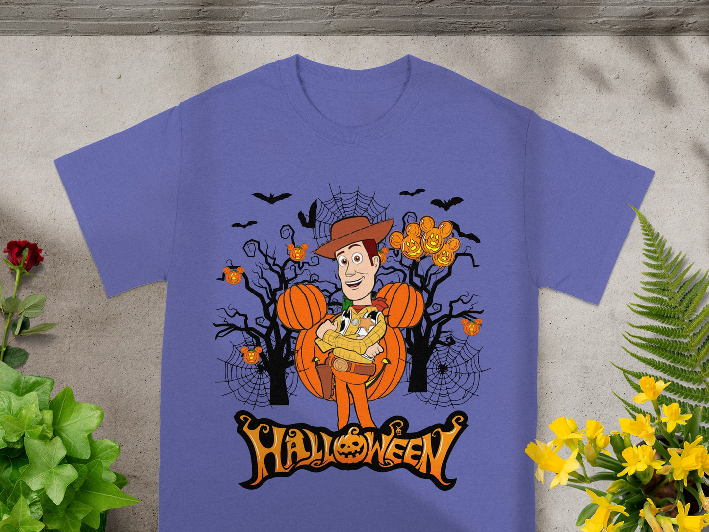 Woody character in Halloween scene with pumpkins, bats, and spiderwebs, and "Halloween" text.