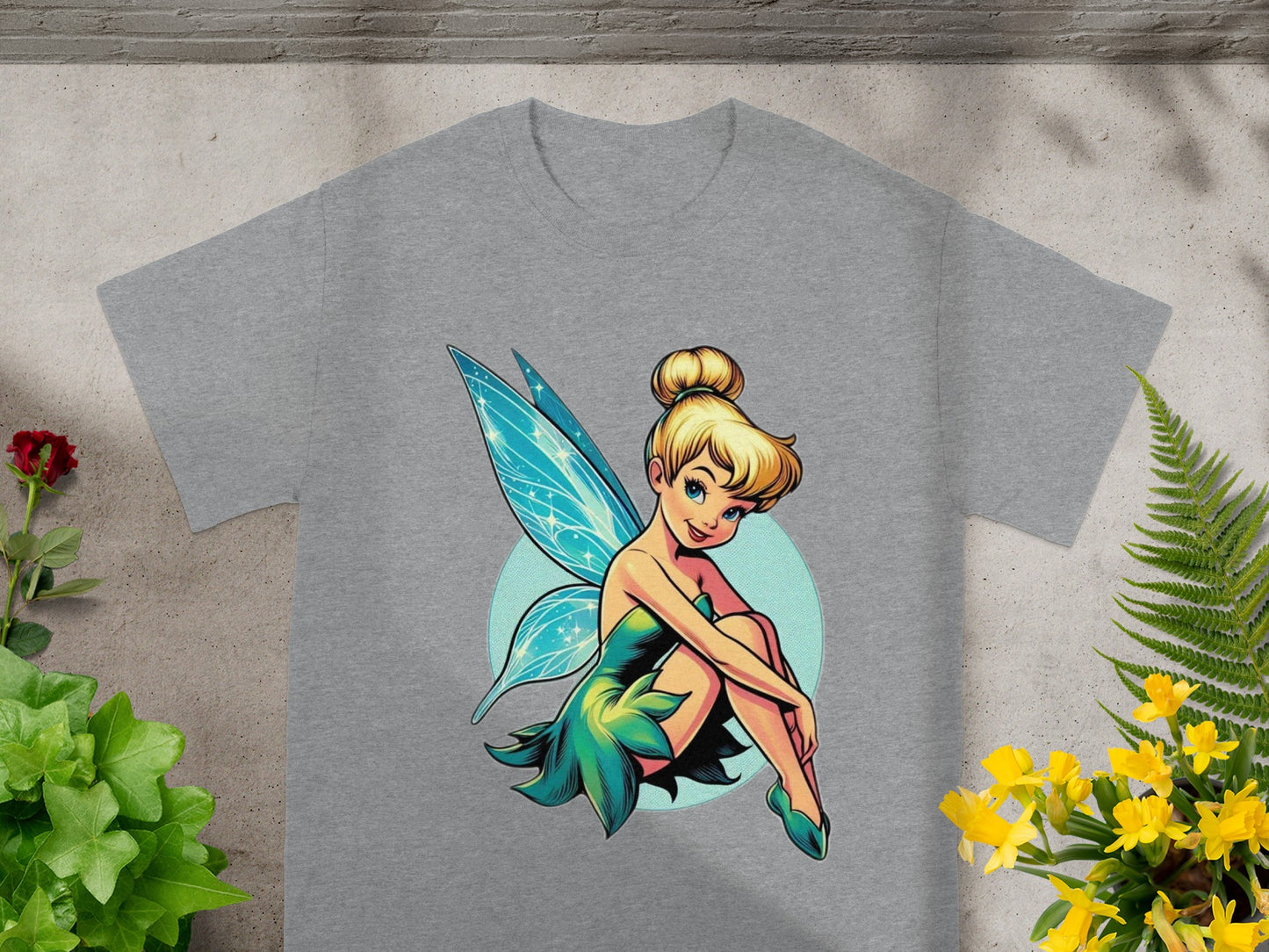 Tinkerbell fairy sitting on a light blue circle with teal wings.