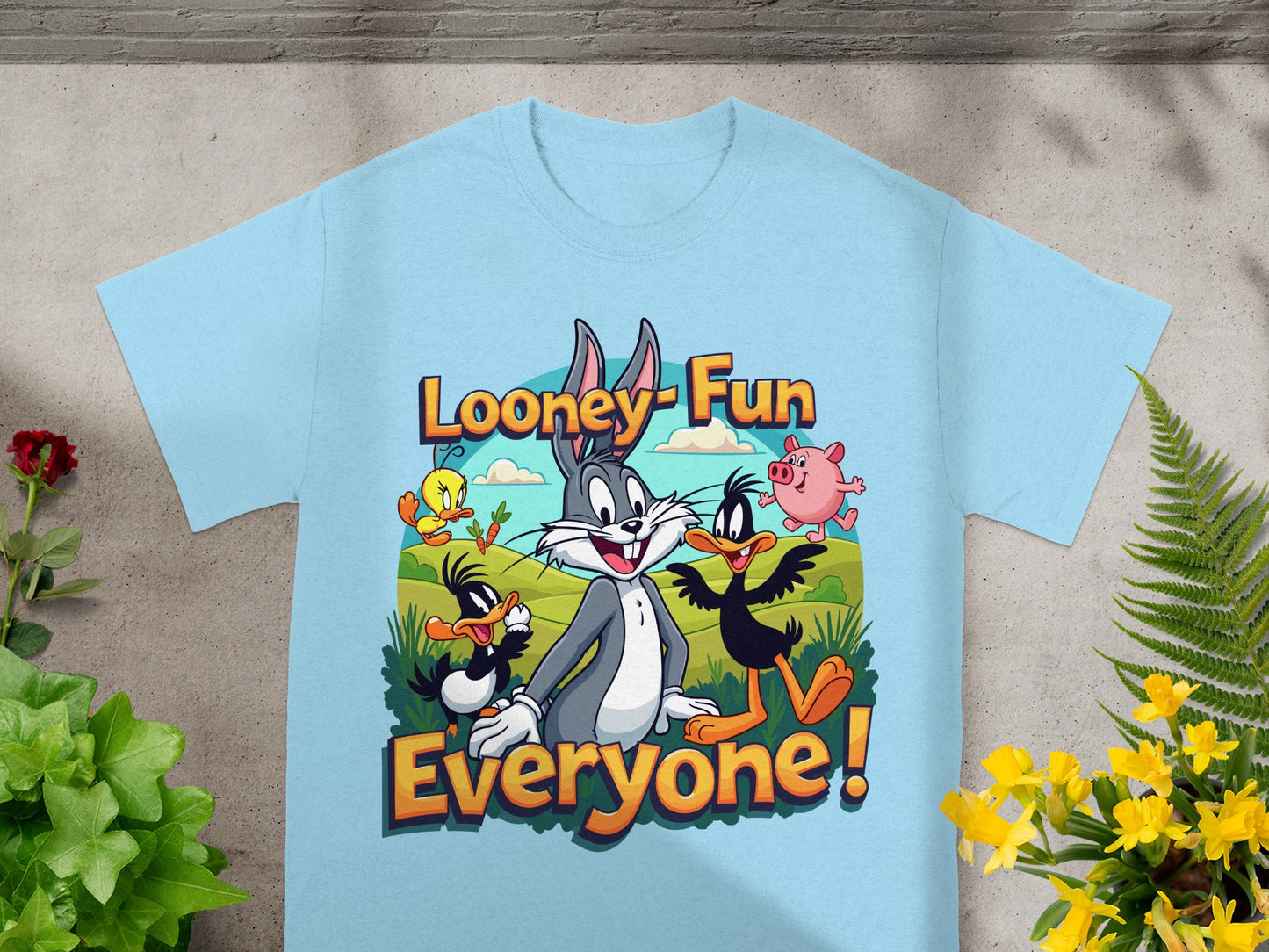 Looney Tunes characters Bugs Bunny, Daffy Duck, Porky Pig, and tweety on a light blue t-shirt.