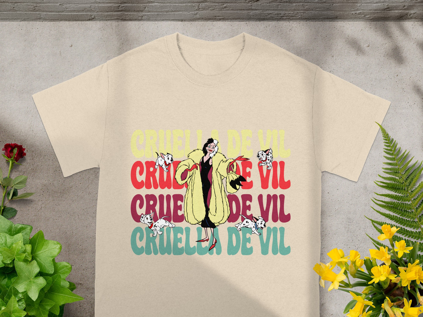 Cruella de Vil graphic with a tan t-shirt.