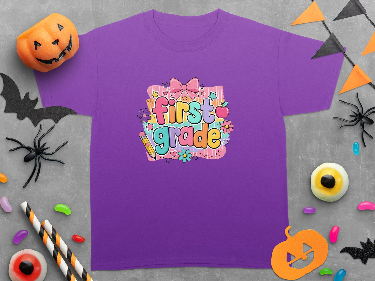 Purple t-shirt with "first grade" text, surrounded by Halloween decor.