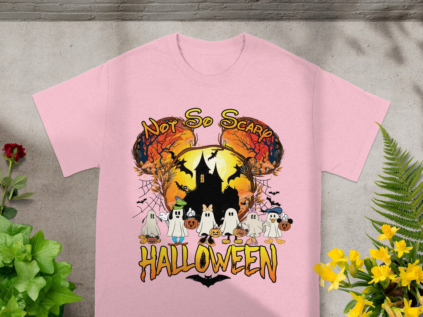 Pink t-shirt with "Not So Scary Halloween" featuring ghosts and a haunted house.