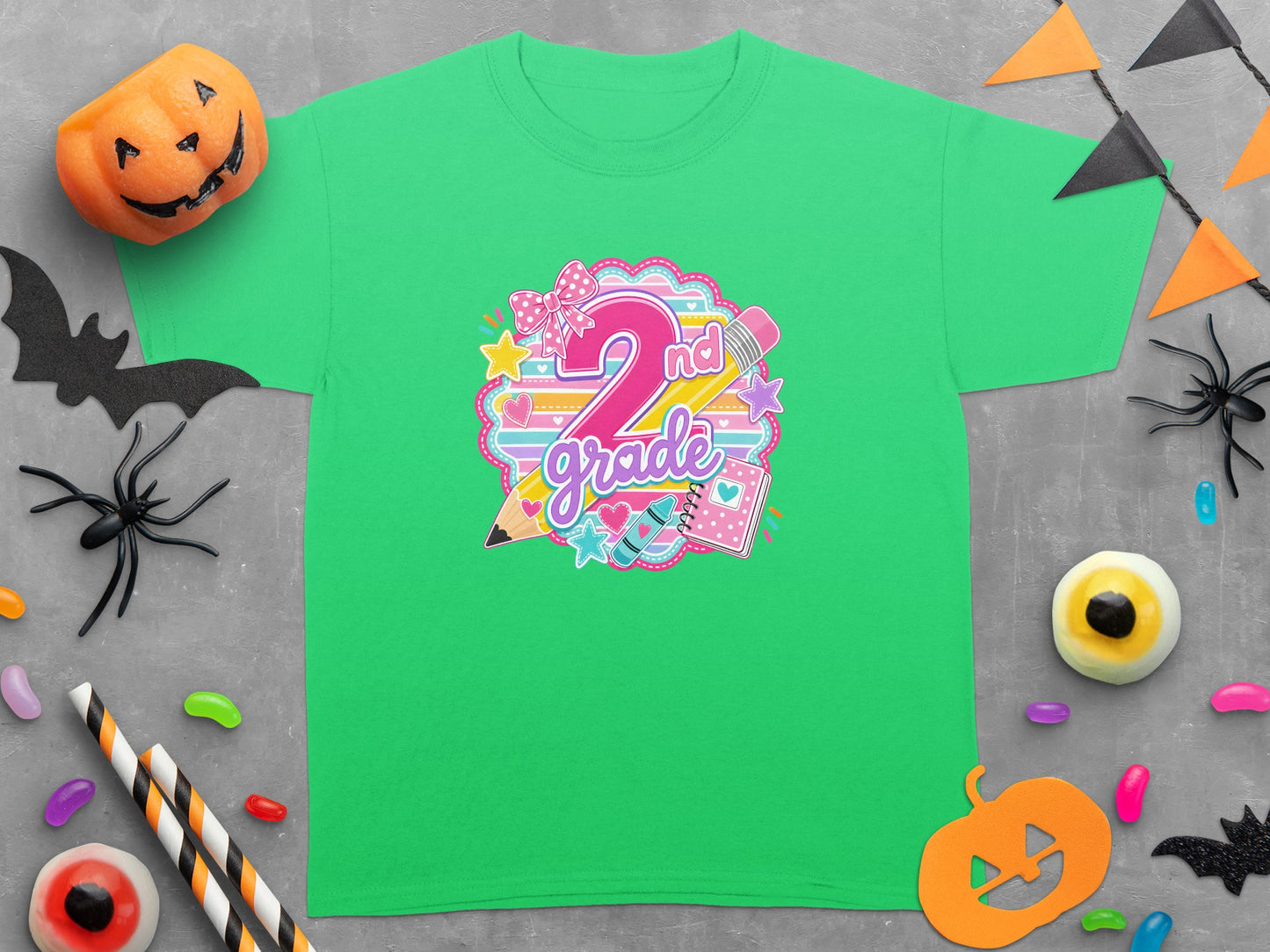 Green t-shirt with "2nd Grade" graphic featuring a large pink 2, pencil, and crayon.