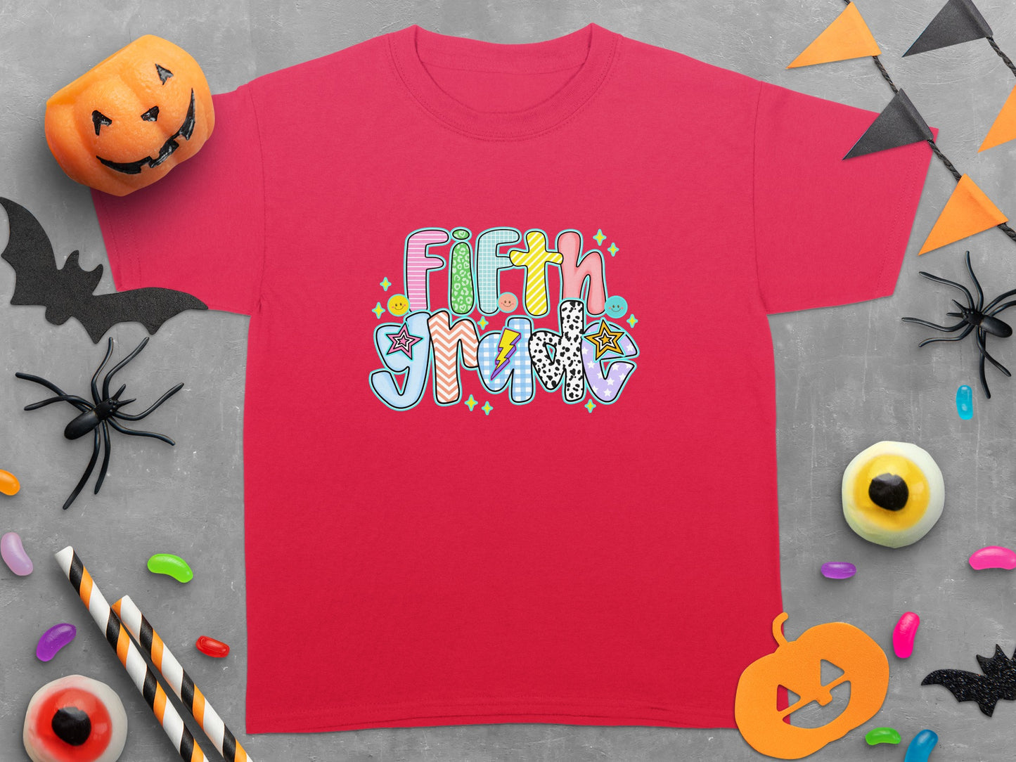 Red t-shirt with "Fifth Grade" text in colorful, patterned letters.