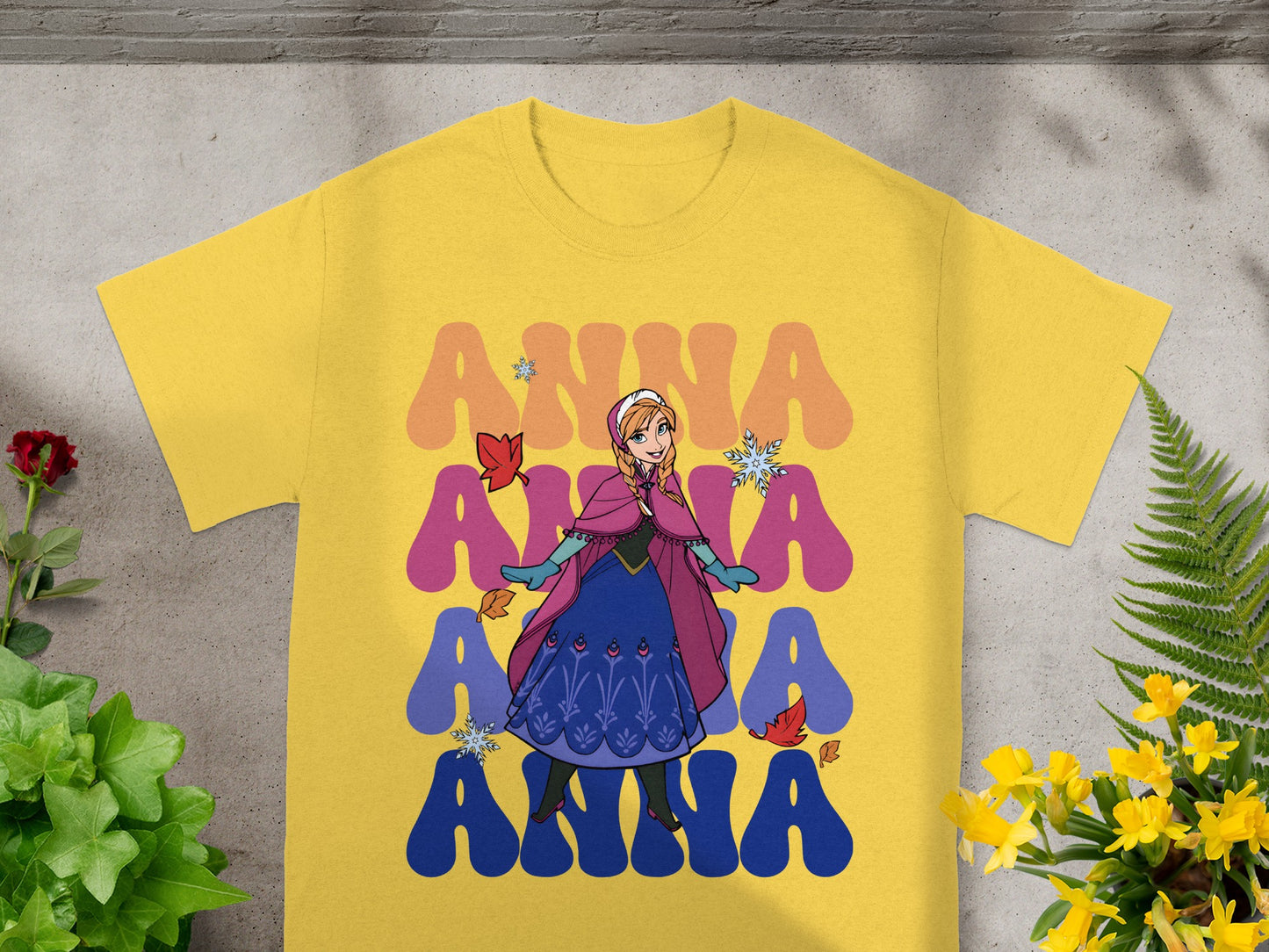 Yellow t-shirt with Anna from Frozen graphic and colorful "Anna" text.