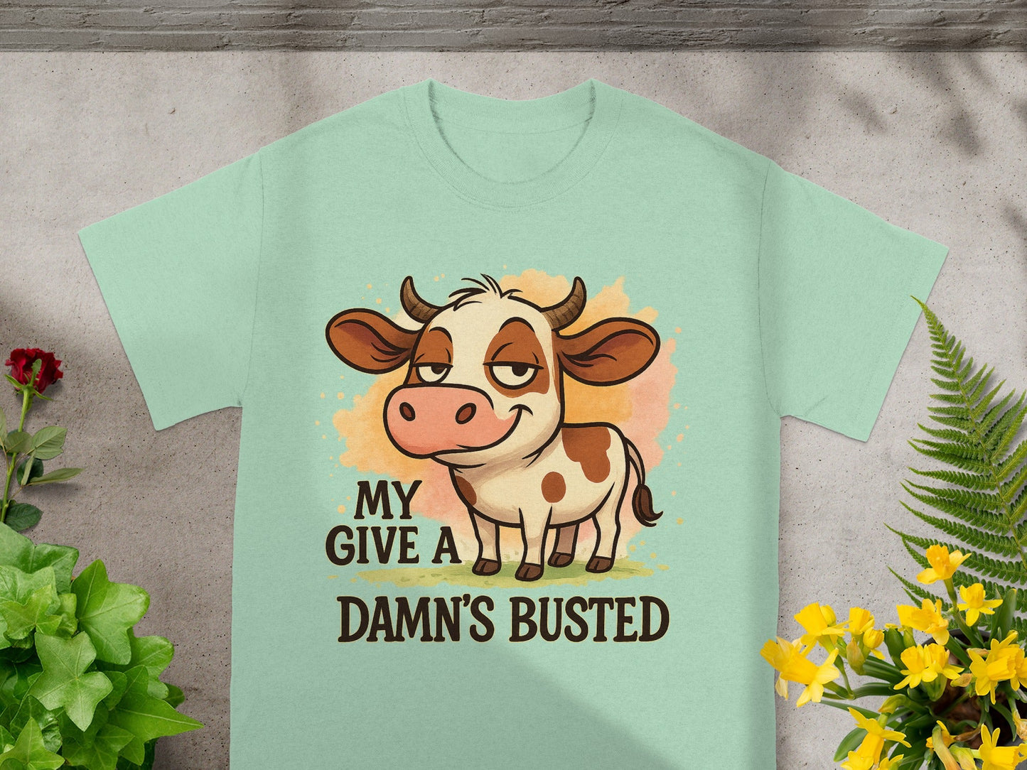 Light mint t-shirt with cartoon cow and text "MY DAMN'S BUSTED".
